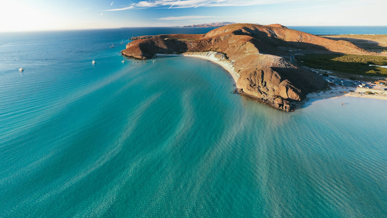 Fotografía aérea real de aguas turquesas y montañas costeras en La Paz, Baja California Sur, México
